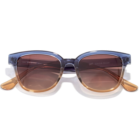 Sunglasses with a blue frame and brown lenses on a white background