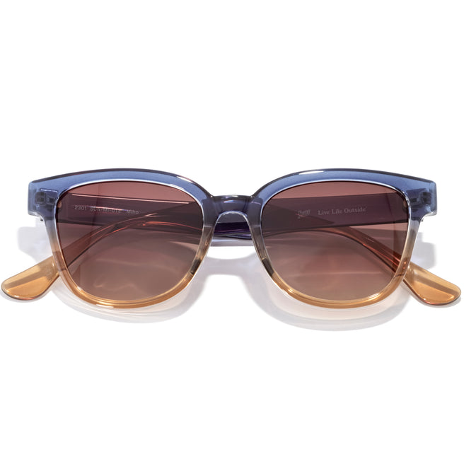 Sunglasses with a blue frame and brown lenses on a white background