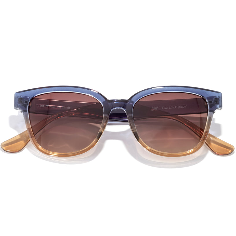 Sunglasses with a blue frame and brown lenses on a white background