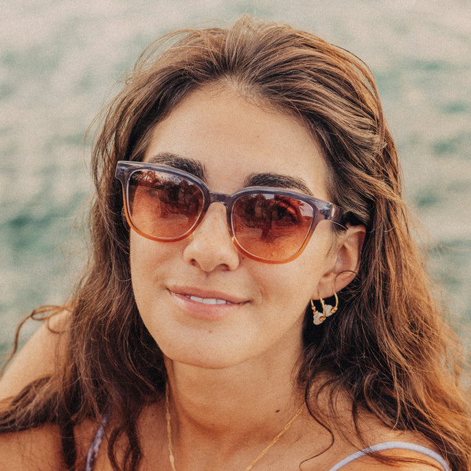 Woman wearing sunglasses with a blurred natural background