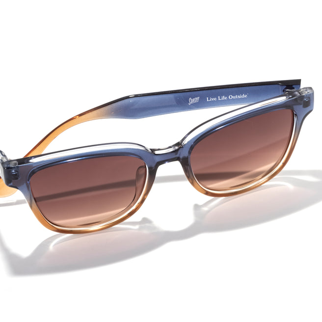 Sunglasses with a gradient frame and brown lenses on a white background