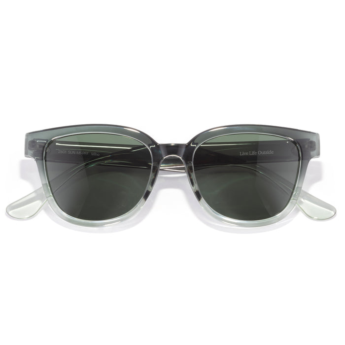 Sunglasses with clear frame and dark lenses on a white background