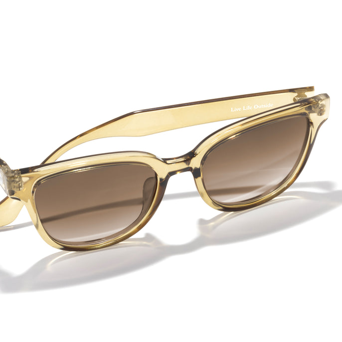 Gold-framed sunglasses with brown lenses on a white background