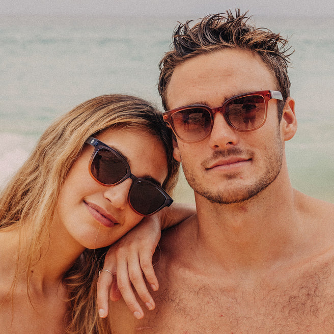 Couple wearing sunglasses by the beach