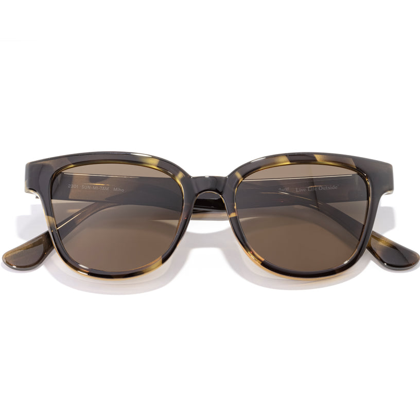 Sunglasses with tortoiseshell frame and brown lenses on a white background