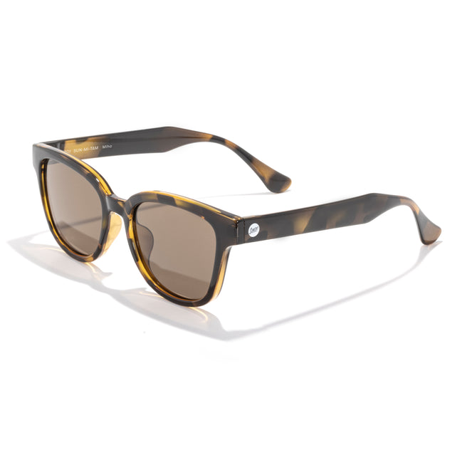 Sunglasses with tortoiseshell frame and brown lenses on a white background