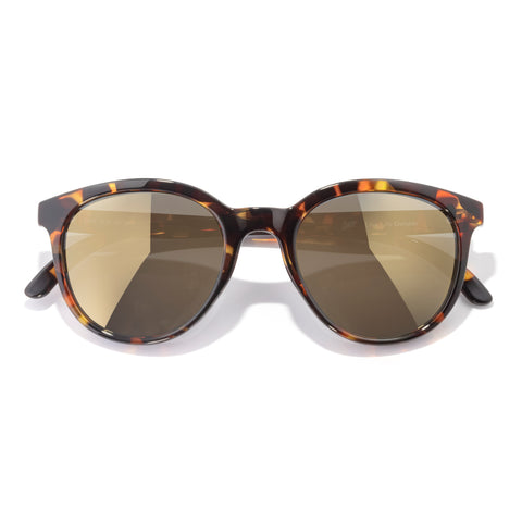 Tortoiseshell sunglasses with brown lenses on a white background