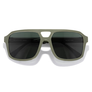 Sunglasses with green frame and dark lenses on a white background