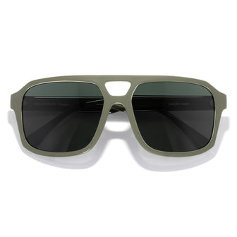 Sunglasses with green frame and dark lenses on a white background