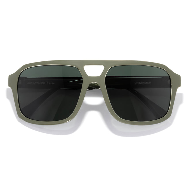 Sunglasses with green frame and dark lenses on a white background