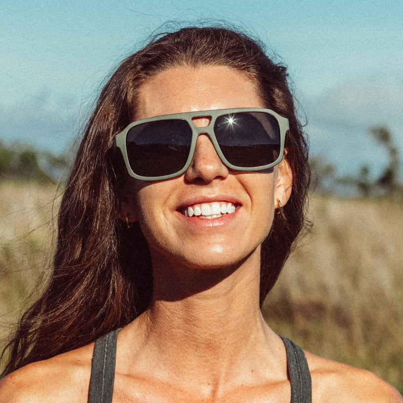 Woman wearing sunglasses with a blurred natural background