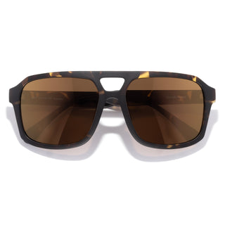 Sunglasses with tortoiseshell frame and brown lenses on a white background