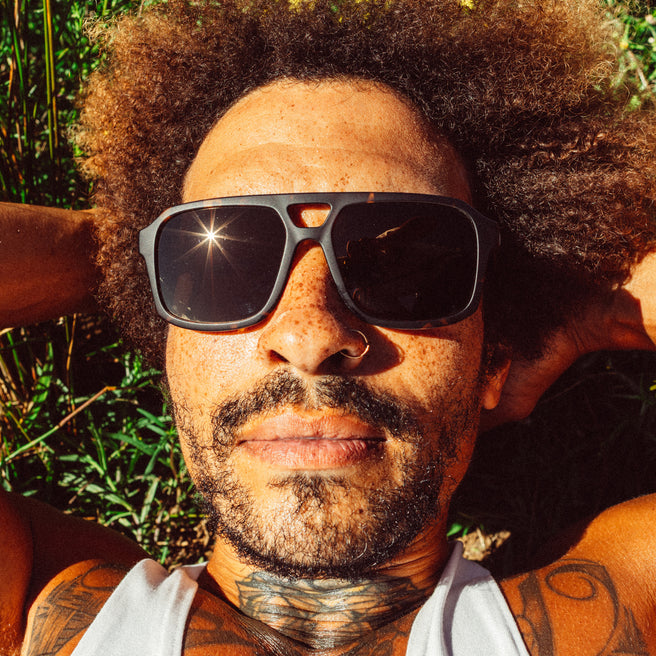 Man with sunglasses and tattoos outdoors