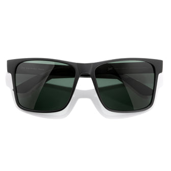Black sunglasses with dark lenses on a white background
