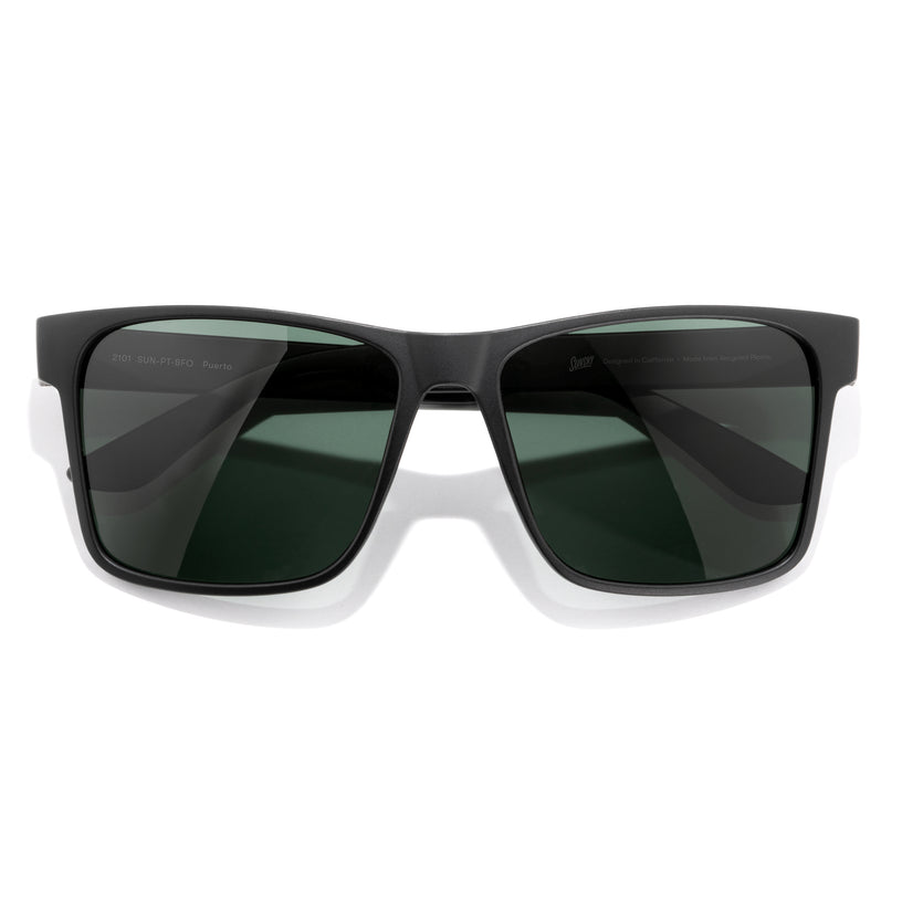 Black sunglasses with dark lenses on a white background