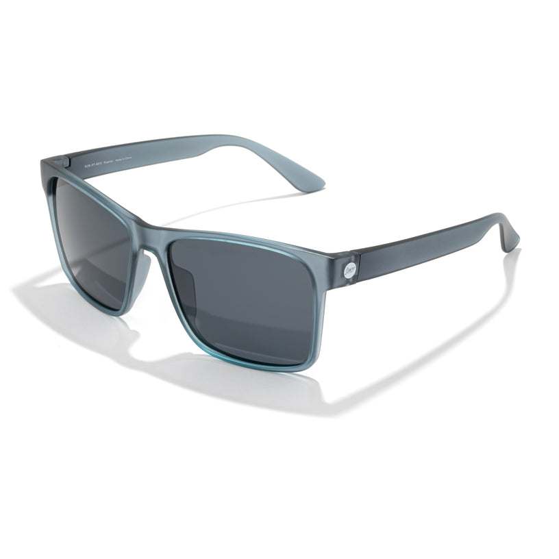 Sunglasses with blue frames and dark lenses on a white background
