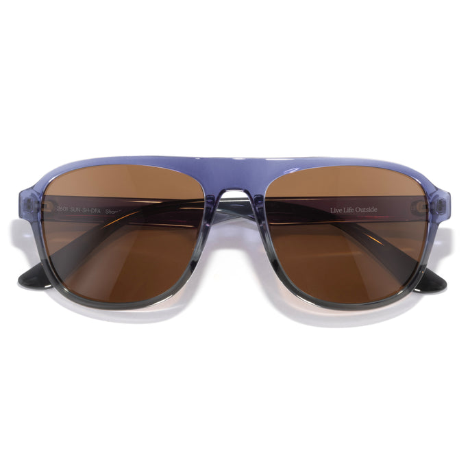 Shoreline - Dusk Fade Amber - Sunglasses with brown lenses and a blue frame on a white background