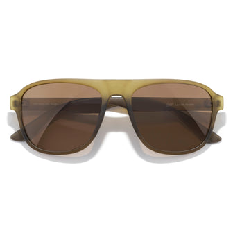 Sunglasses with brown lenses and gold frame on a white background