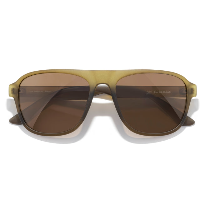 Sunglasses with brown lenses and gold frame on a white background