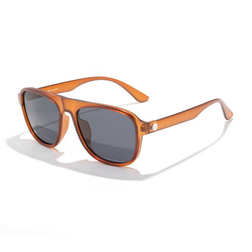 Sunglasses with brown frame and dark lenses on a white background