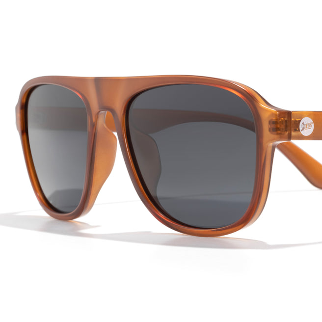 Brown sunglasses with dark lenses on a white background