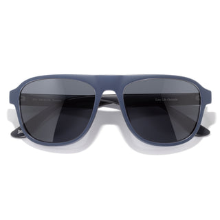 Blue sunglasses with dark lenses on a white background