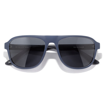 Blue sunglasses with dark lenses on a white background
