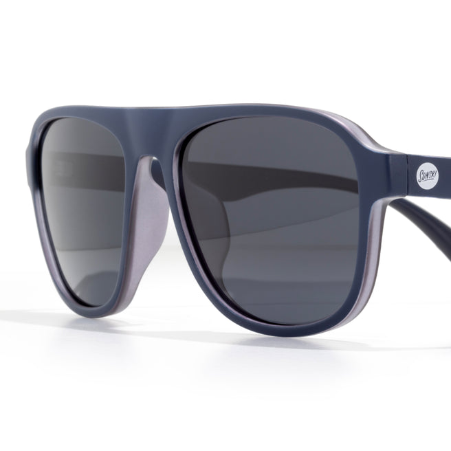 Blue sunglasses with dark lenses on a white background