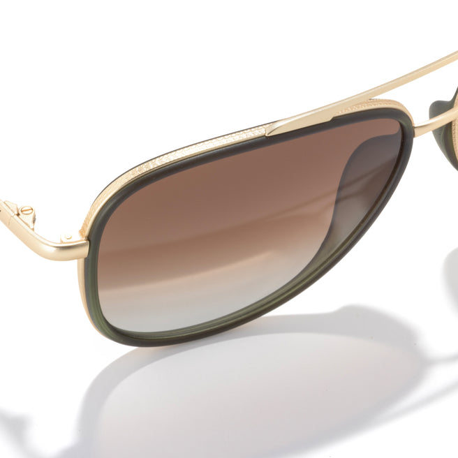 Gold-framed sunglasses with brown gradient lenses on a white background