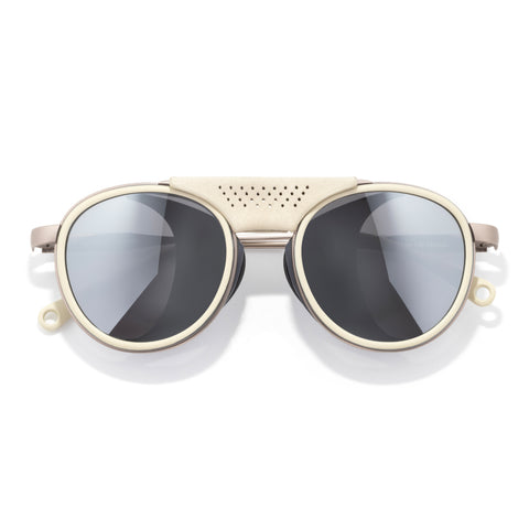 Sunglasses with gold frame and dark lenses on a white background