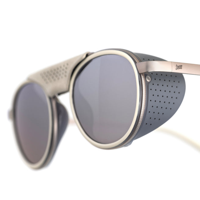 Sunglasses with round lenses and metallic frame on a white background