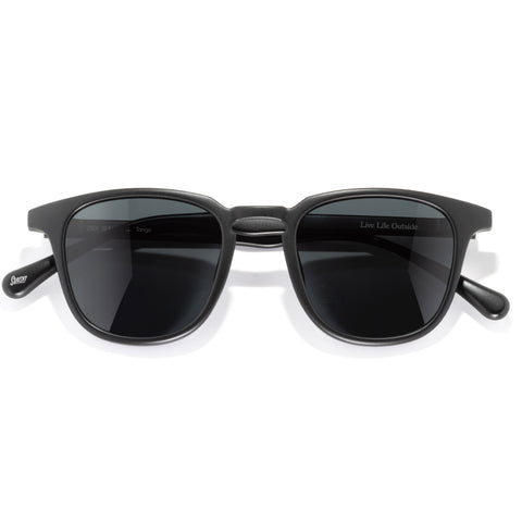 Black sunglasses with dark lenses on a white background