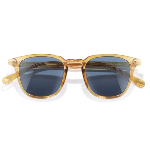 Gold-framed sunglasses with blue lenses on a white background