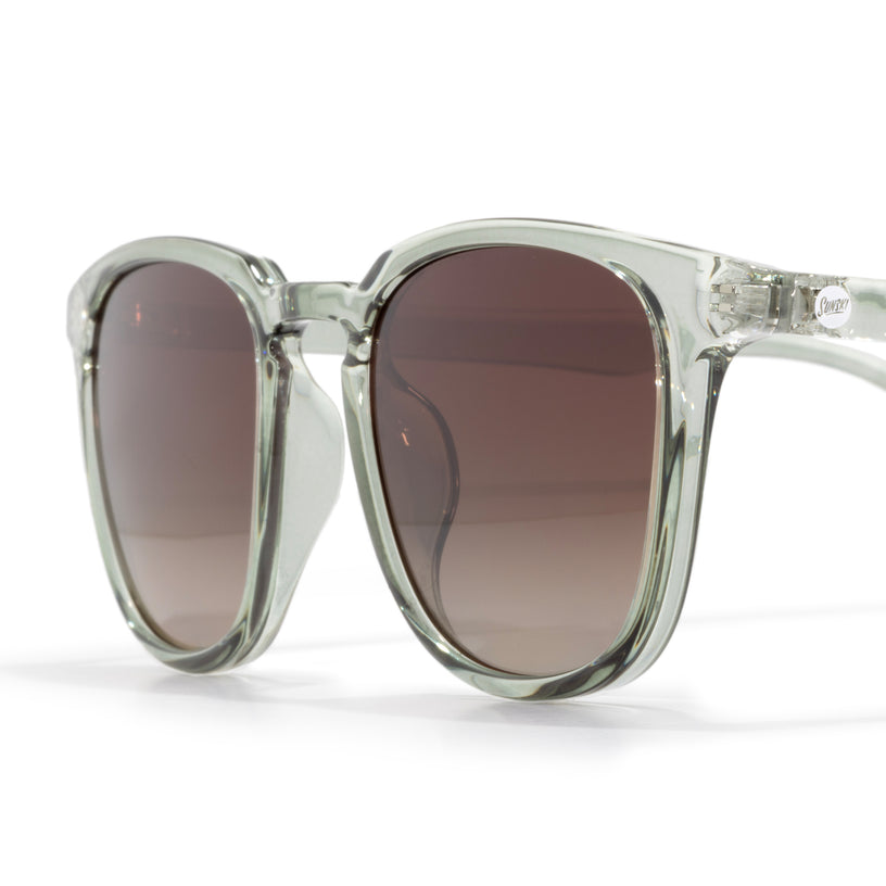 Clear frame sunglasses with brown gradient lenses on a white background