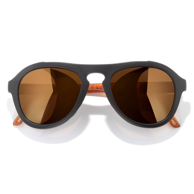 Sunglasses with black frame and brown lenses on a white background