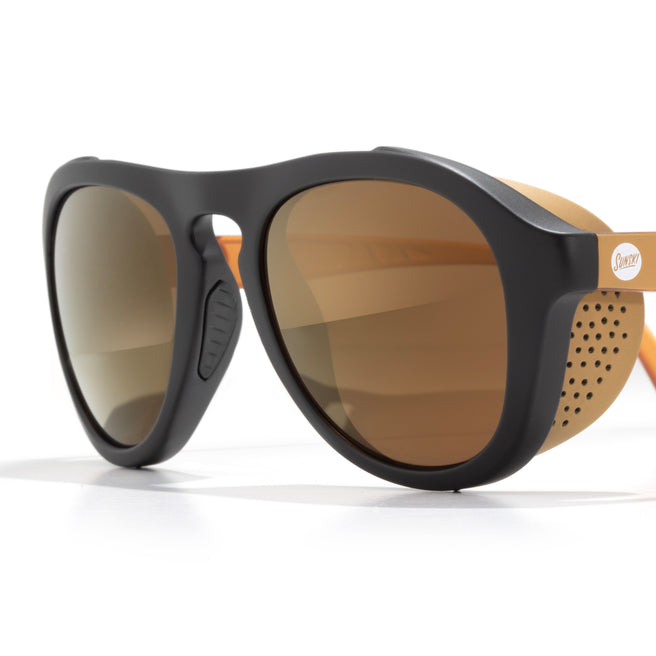 Sunglasses with black frame and brown lenses on a white background