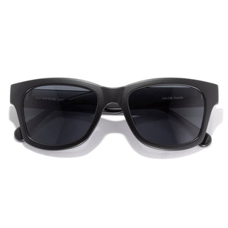 Black sunglasses with dark lenses on a white background