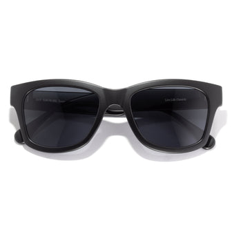 Black sunglasses with dark lenses on a white background