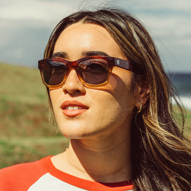 Woman wearing sunglasses with a blurred natural background