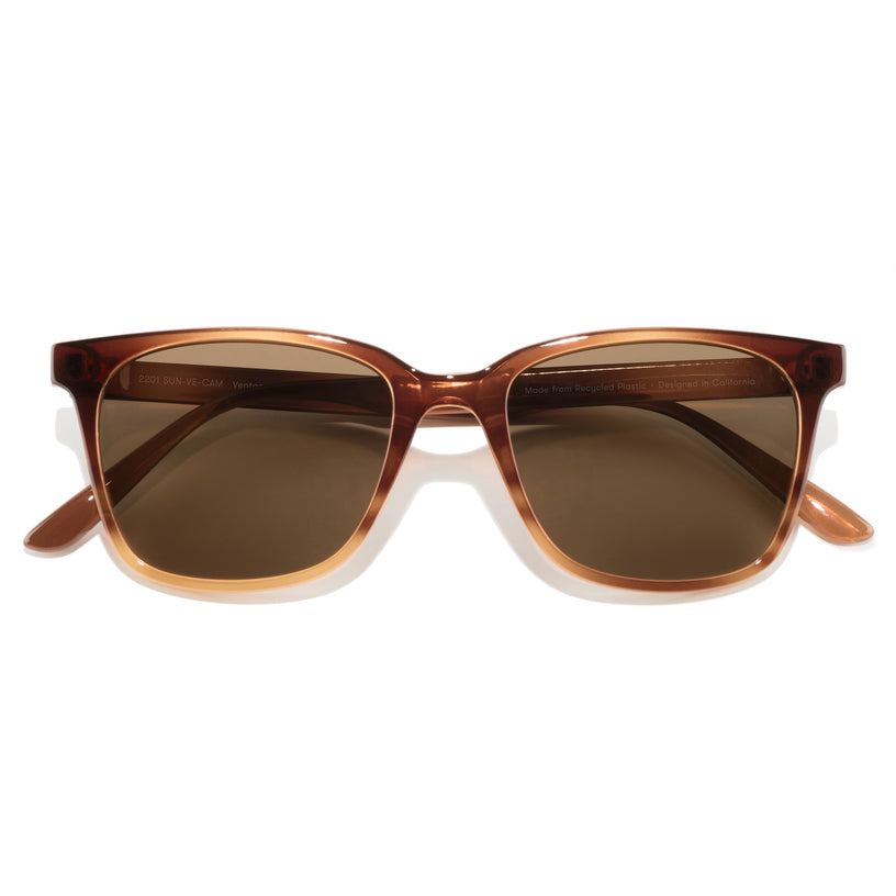 Brown sunglasses with a reflective surface on a white background