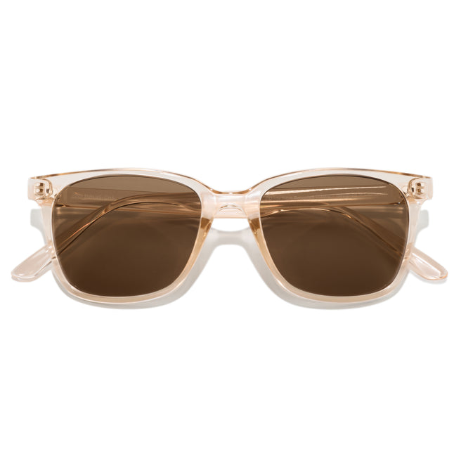 Sunglasses with a beige frame and brown lenses on a white background