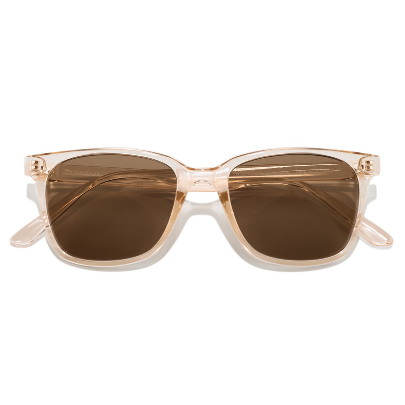 Sunglasses with a beige frame and brown lenses on a white background