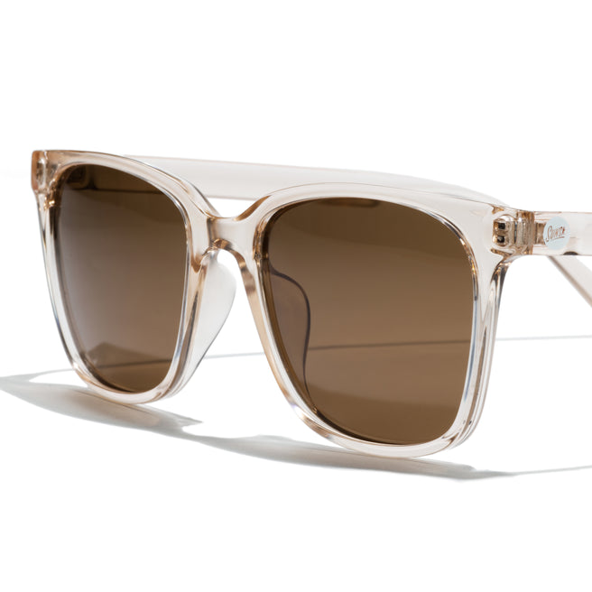 Clear frame sunglasses with brown lenses on a white background
