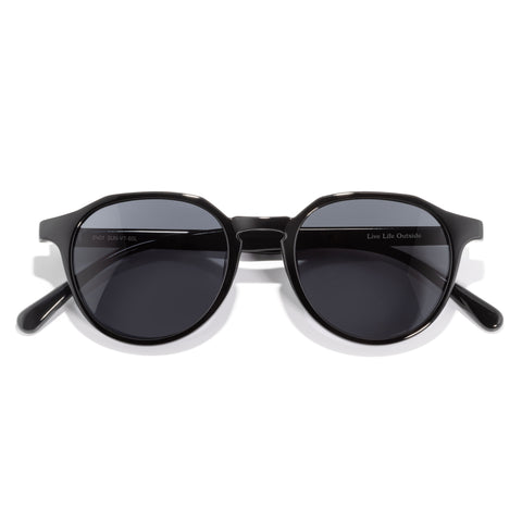 Black sunglasses with dark lenses on a white background