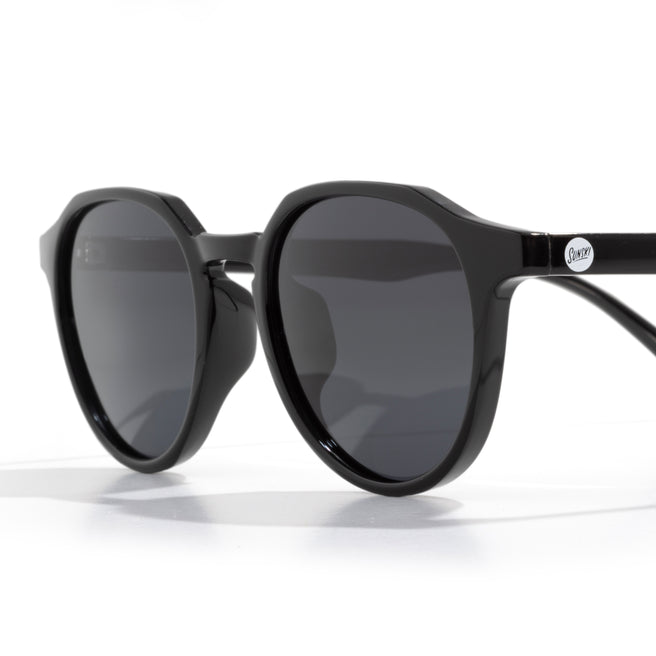 Black sunglasses with dark lenses on a white background