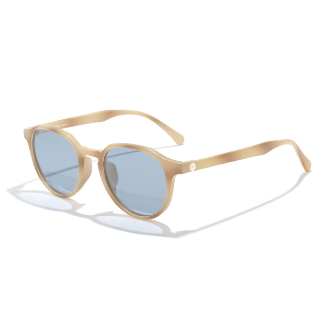 Beige sunglasses with blue lenses on a white background