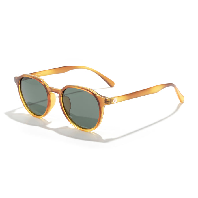 Gold-framed sunglasses with green lenses on a white background