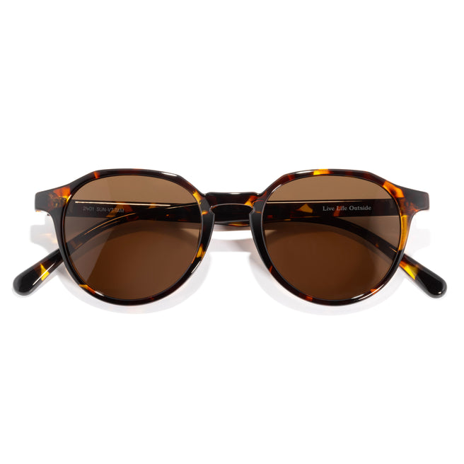 Sunglasses with tortoiseshell frame and brown lenses on a white background