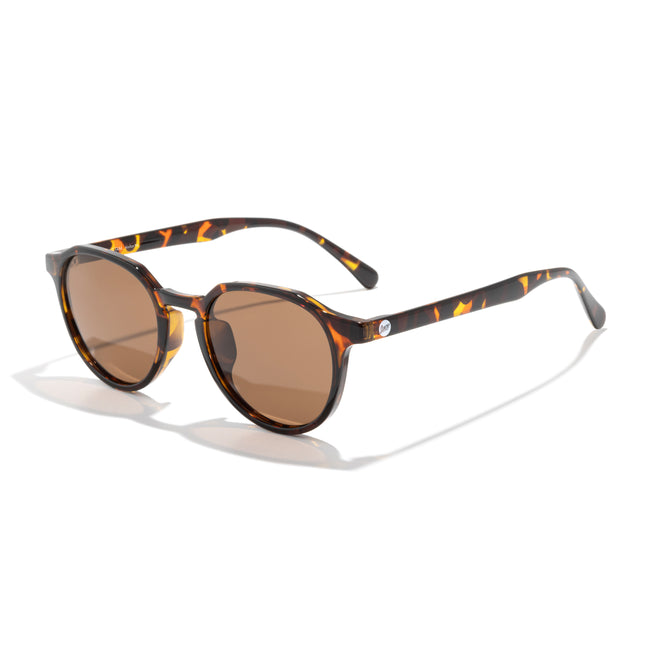 Sunglasses with tortoiseshell frame and brown lenses on a white background