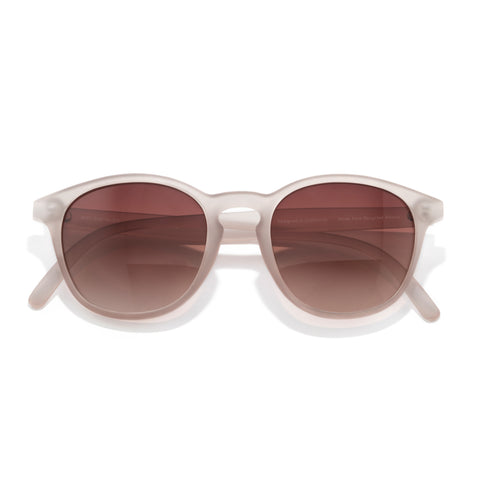 Sunglasses with white frame and brown gradient lenses on a white background